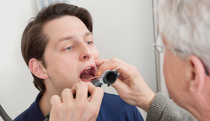 Man having throat examined